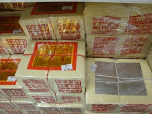 Stacks of ghost money, also called joss paper for sale at a store. Photo by Sjschen