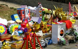 A collection of paper items that will be burned for the ancestors so that they may have these things in the spirit world.